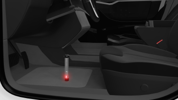 WLT 12.C needle probe with safety guard inserted through vehicle carpet in driver’s footwell, detecting hidden water using WLT 200 tester with sound and light alert in automotive water ingress detection